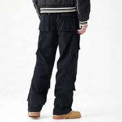 Black cargo pants with multiple flap pockets and panel detailing