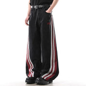 Black wide-leg jeans with red and white side stripe panels