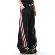 Black wide-leg jeans with red and white side stripe panels