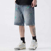 Light blue denim shorts with paint splatter detailing
