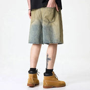 Olive green washed denim shorts with subtle distressing