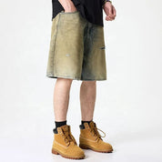 Olive green washed denim shorts with subtle distressing